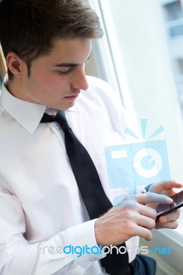 Young Businessman Using His Mobile Phone In Office Stock Photo