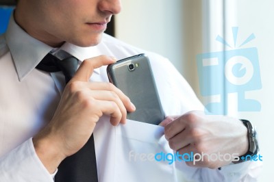 Young Businessman Using His Mobile Phone In Office Stock Photo