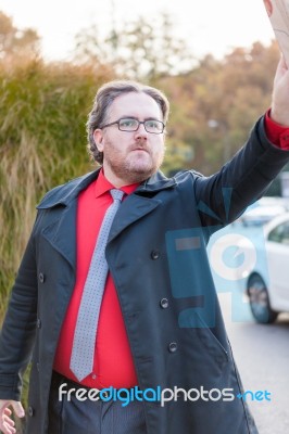 Young Businessman With A Newspaper Calling Someone's Attention Stock Photo