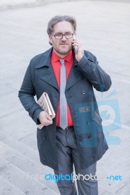 Young Businessman With A Newspaper With An Smartphone Stock Photo