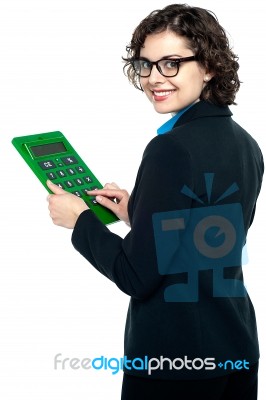 Young Businesswoman Using Calculator Stock Photo