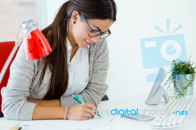 Young Businesswoman Working In Her Office With Laptop Stock Photo