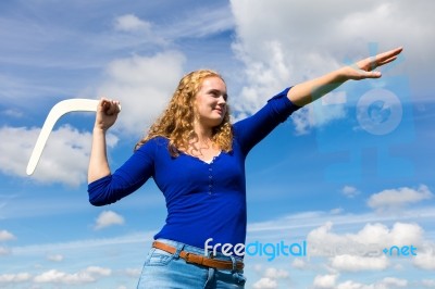 Young Caucasian Woman Throwing Boomerang Stock Photo