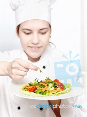 Young Chef Decorating Delicious Salad Stock Photo