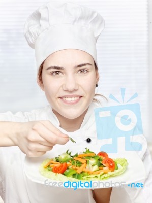 Young Chef Decorating Delicious Salad Stock Photo