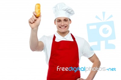 Young Chef Holding Bread Roll Stock Photo