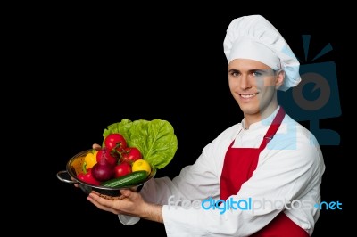 Young Chef Holding Colander With Fresh Vegetables Stock Photo