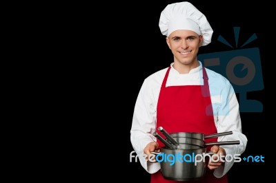 Young Chef Holding Empty Vessels In Hands Stock Photo