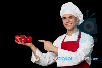 Young Chef Holding Fresh Tomatoes Stock Photo