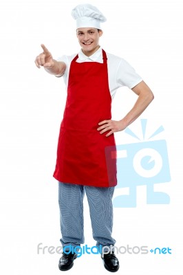 Young Chef Pointing Forward Stock Photo