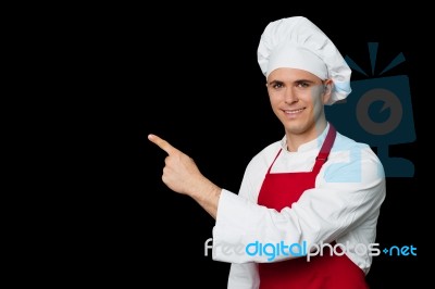 Young Chef Pointing Towards Something Stock Photo