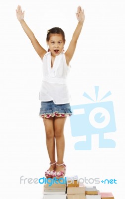 Young Child Standing On Books Stock Photo