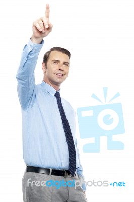 Young Consultant Indicating In Upward Direction Stock Photo