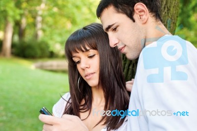 Young Couple And Mobile Phone Stock Photo