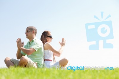 Young Couple Doing Meditating Stock Photo