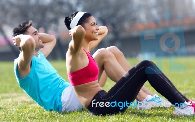 Young Couple Doing Push-ups Stock Photo