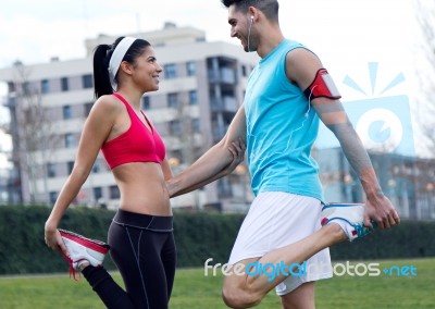 Young Couple Doing Stretching Stock Photo