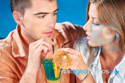 Young Couple Drinking Cocktail Stock Photo