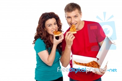 Young Couple Eating Pizza Stock Photo