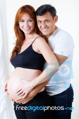 Young Couple Expecting Baby. Isolated On White Stock Photo