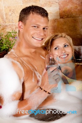 Young Couple Having Bath With Wine Stock Photo