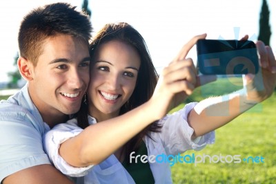 Young Couple Having Fun In A Park Stock Photo