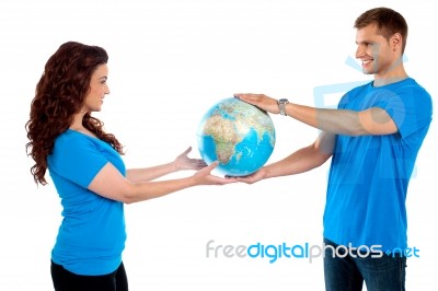 Young Couple Holding Globe Together Stock Photo