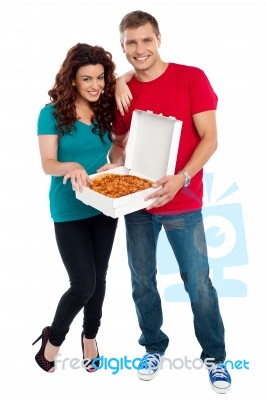 Young Couple Holding Pizza Box Stock Photo