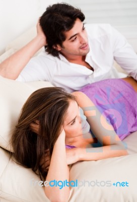 Young Couple Lying In Couch Stock Photo