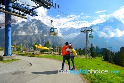 Young Couple Of Travelers Enjoying A Mountains View In The Summe… Stock Photo