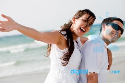 Young Couple Piggy Backing Stock Photo