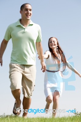 Young Couple Running Stock Photo