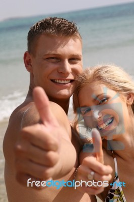 Young Couple Showing Thumbs Up Stock Photo