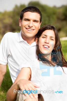 Young Couple Sitting Stock Photo