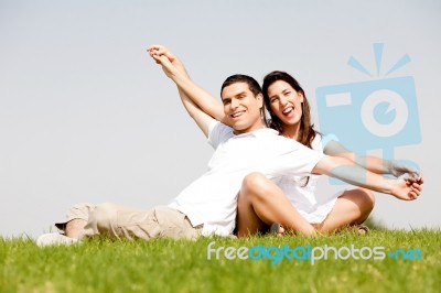 Young Couple Sitting Together Stock Photo