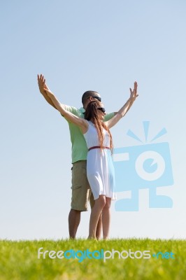 Young Couple Stretching Hands Stock Photo