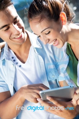 Young Couple Using A Digital Tablet Stock Photo