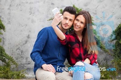 Young Couple Using Smart Phone Stock Photo