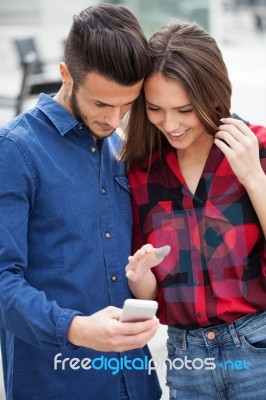 Young Couple Using Smart Phone Stock Photo