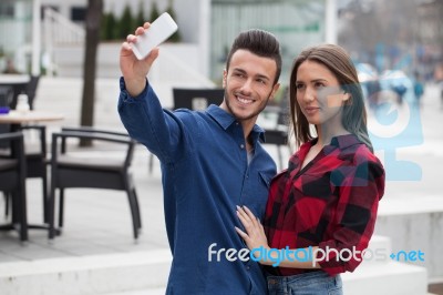 Young Couple Using Smart Phone Stock Photo