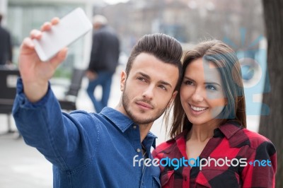 Young Couple Using Smart Phone Stock Photo