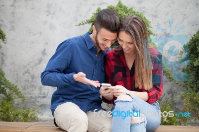 Young Couple Using Smart Phone Stock Photo