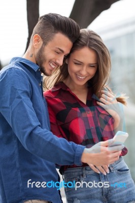 Young Couple Using Smart Phone Stock Photo