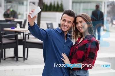 Young Couple Using Smart Phone Stock Photo