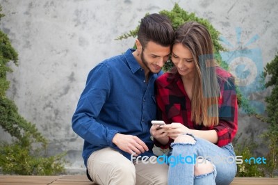 Young Couple Using Smart Phone Stock Photo