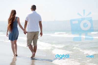 Young Couple Walk At The Beach Stock Photo