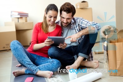 Young Couple With Digital Tablet In Their New Home Stock Photo