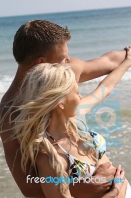 Young Couples At Beach Stock Photo