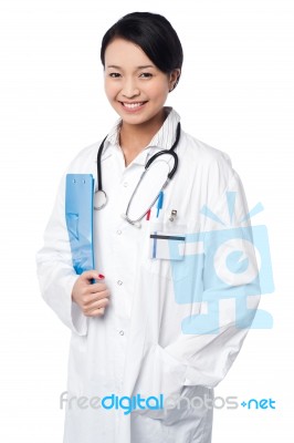 Young Doctor Holding Clipboard Stock Photo