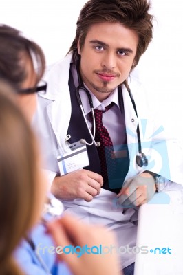 Young Doctor Sitting With Hospital Staff Stock Photo